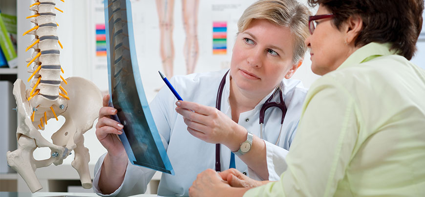 chiropractor discussing x-ray results with patient